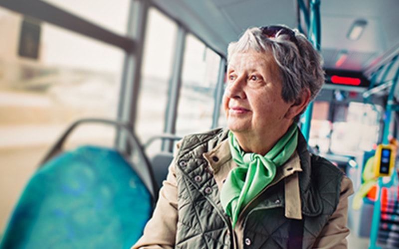 Elderly woman riding the bus to a doctor's appointment